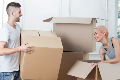 Trained moving staff handling furniture carefully in a narrow space