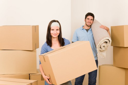 Removals team handling office equipment in a Notting Hill street setting